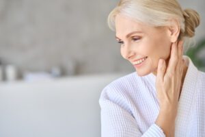 smiling middle aged woman in white bathrobe